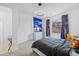 Bright bedroom with a colorful accent wall, modern dresser, and view of the neighborhood at 16202 W 95Th Ln, Arvada, CO 80007