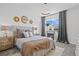 Cozy bedroom with tufted headboard, modern lighting, and a decorative fireplace at 16202 W 95Th Ln, Arvada, CO 80007