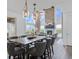 Dining area with views of the living room and outside with large table and seating for eight at 16202 W 95Th Ln, Arvada, CO 80007