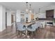 Dining area with a table and chairs and views of the kitchen and access to backyard at 16202 W 95Th Ln, Arvada, CO 80007