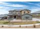 Beautiful two-story home with stone accents and a well-manicured lawn and inviting covered front porch at 16202 W 95Th Ln, Arvada, CO 80007
