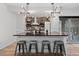 Modern kitchen island featuring counter seating, pendant lighting, and brick backsplash at 16202 W 95Th Ln, Arvada, CO 80007