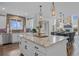 Bright kitchen features a large center island with granite countertops and pendant lighting at 16202 W 95Th Ln, Arvada, CO 80007
