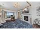 Spacious main bedroom featuring a fireplace, mounted tv, and balcony at 16202 W 95Th Ln, Arvada, CO 80007