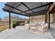 Covered patio featuring a fire pit and comfortable seating area at 16202 W 95Th Ln, Arvada, CO 80007