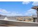 Expansive view from the deck overlooking rooftops and rolling hills, highlighting the scenic landscape at 16202 W 95Th Ln, Arvada, CO 80007