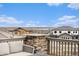 Stunning mountain views from the deck, complemented by outdoor seating and stylish railing at 16202 W 95Th Ln, Arvada, CO 80007