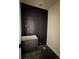 Modern bathroom features dark tile walls, floating vanity cabinet, and a sleek design at 1555 Arrowpoint Ct, Franktown, CO 80116