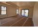 Bedroom featuring a tray ceiling, multiple windows, neutral walls, and access to the outdoor living space at 1555 Arrowpoint Ct, Franktown, CO 80116