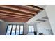 Modern room showcasing newly installed ceiling beams and large windows providing abundant natural light at 1555 Arrowpoint Ct, Franktown, CO 80116