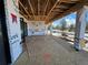 Unfinished deck with Tyvek house wrap showing lumber frame and view of trees under a blue sky at 1555 Arrowpoint Ct, Franktown, CO 80116