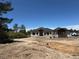 New construction home featuring stone accents, a dark roof, and a bright exterior paint against a blue sky at 1555 Arrowpoint Ct, Franktown, CO 80116