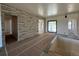Open-concept living room featuring a decorative stone wall, bright interior paint, and access to the outdoor space at 1555 Arrowpoint Ct, Franktown, CO 80116