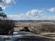 Expansive landscape view showcasing rolling hills, scattered homes, and majestic snow-capped mountain peaks in the distance at 1555 Arrowpoint Ct, Franktown, CO 80116