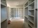 Large walk-in closet with custom shelving providing ample storage and organization space at 1555 Arrowpoint Ct, Franktown, CO 80116