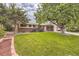 House exterior with mature trees and lawn at 3004 S Ingalls Way, Denver, CO 80227