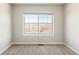 Bright, neutral bedroom featuring a large window with neighborhood views and neutral carpet at 7440 E 8Th Ave # 25, Denver, CO 80230