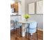 Modern dining area featuring a round table and blue chairs, with views of the kitchen at 7440 E 8Th Ave # 25, Denver, CO 80230