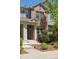 Charming brick townhome featuring a well-manicured front yard and inviting front porch at 7440 E 8Th Ave # 25, Denver, CO 80230