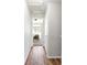 Hallway with hardwood floors and neutral walls leading into a bedroom at 7440 E 8Th Ave # 25, Denver, CO 80230