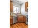 Bright kitchen featuring wooden cabinets, stainless steel appliances, and natural light from the window at 7440 E 8Th Ave # 25, Denver, CO 80230