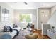 Bright living room featuring hardwood floors, neutral walls, with lots of natural light from a large window at 7440 E 8Th Ave # 25, Denver, CO 80230