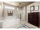Bright bathroom featuring a soaking tub, glass-enclosed shower, and modern fixtures at 9741 Chambers Dr, Commerce City, CO 80022