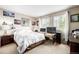 Bright bedroom with large windows, a comfortable bed, and ample natural light at 9741 Chambers Dr, Commerce City, CO 80022