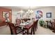 Charming dining room with large table, chandelier, and colorful wall art at 9741 Chambers Dr, Commerce City, CO 80022
