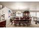Well-lit dining area features a wooden table, eight chairs, and built in cabinet for storage at 9741 Chambers Dr, Commerce City, CO 80022