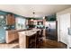 Bright kitchen with stainless steel appliances, center island, and natural light at 9741 Chambers Dr, Commerce City, CO 80022