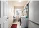Clean laundry room includes washer and dryer, plus storage shelving and a drying rack at 9741 Chambers Dr, Commerce City, CO 80022