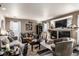 Cozy living room featuring a fireplace, comfortable seating, and natural light at 9741 Chambers Dr, Commerce City, CO 80022