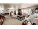 Spacious living room features comfortable seating, elegant décor, and natural light from large windows at 9741 Chambers Dr, Commerce City, CO 80022