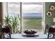 Scenic view from the home of fields and mountains, framed by dining table at 9741 Chambers Dr, Commerce City, CO 80022