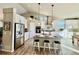 Modern kitchen with stainless steel appliances, a center island, and bright lighting at 2573 Lakes Edge Dr, Monument, CO 80132