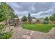 Lush backyard featuring a playground and trampoline, creating a fun-filled space for children to play and explore at 4567 Flanders Way, Denver, CO 80249
