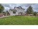 Beautiful backyard with a spacious deck, lush green lawn, providing the perfect outdoor retreat for relaxation and entertaining at 4567 Flanders Way, Denver, CO 80249