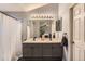 Bathroom featuring double sinks, granite countertops, and modern lighting at 4567 Flanders Way, Denver, CO 80249