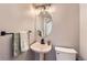 Stylish half bath with pedestal sink, modern fixtures, and decorative mirror at 4567 Flanders Way, Denver, CO 80249