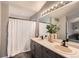 Bathroom featuring double sinks, granite countertops, and modern lighting at 4567 Flanders Way, Denver, CO 80249