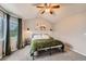 Bedroom featuring a metal frame bed, overhead ceiling fan, and window at 4567 Flanders Way, Denver, CO 80249