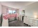 Bedroom with a lofted bed, built-in slide, and direct bathroom access at 4567 Flanders Way, Denver, CO 80249