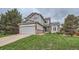 Charming two-story home with a well-manicured lawn, attached garage, and appealing curb appeal at 4567 Flanders Way, Denver, CO 80249
