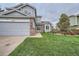 Charming two-story home with well-manicured lawn, brick accents, and attached two-car garage, offering curb appeal and convenience at 4567 Flanders Way, Denver, CO 80249