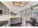 Sunlit kitchen with stainless steel dishwasher, gray cabinets, and a view to outdoor patio space at 4567 Flanders Way, Denver, CO 80249