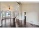Bright living room with hardwood floors and staircase access; open to kitchen and dining at 4567 Flanders Way, Denver, CO 80249