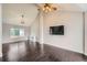 Spacious living room with dark wood floors, vaulted ceiling, and ample natural light at 4567 Flanders Way, Denver, CO 80249
