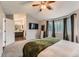 Comfortable bedroom with ample lighting, carpet flooring, and ensuite bathroom at 4567 Flanders Way, Denver, CO 80249
