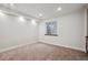Finished basement with a window well, carpet and baseboards at 6687 S Forest Way # E, Centennial, CO 80121